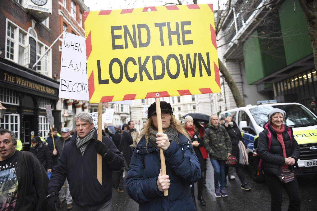 People take part in an anti-vaccination and anti-lockdown protest in London on Monday. Photo: PA via AP