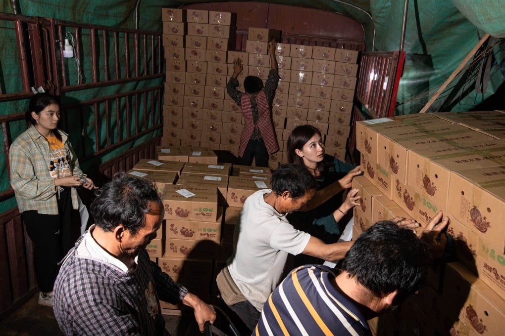Workers load a truck with pomegranates in Zhangguan, in Sichuan Province, in September. Photo: Xinhua