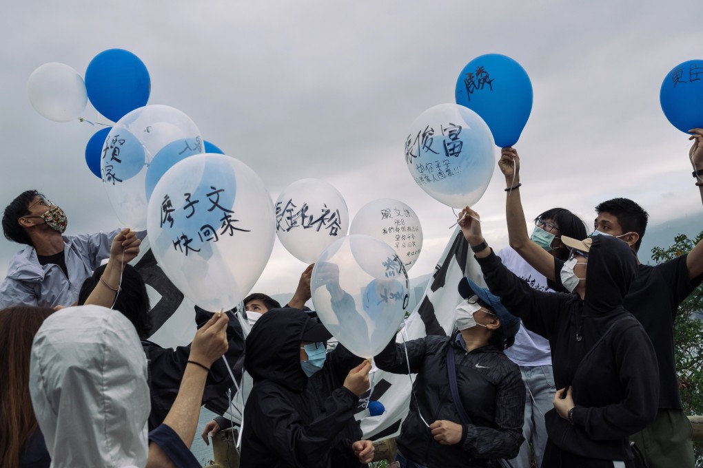 Activists and family members of 12 Hongkongers detained in mainland China prepare to release balloons, marked with the names of the detainees, towards the Yantian area of Shenzhen from Crooked Island in Hong Kong on November 21. Photo: Bloomberg