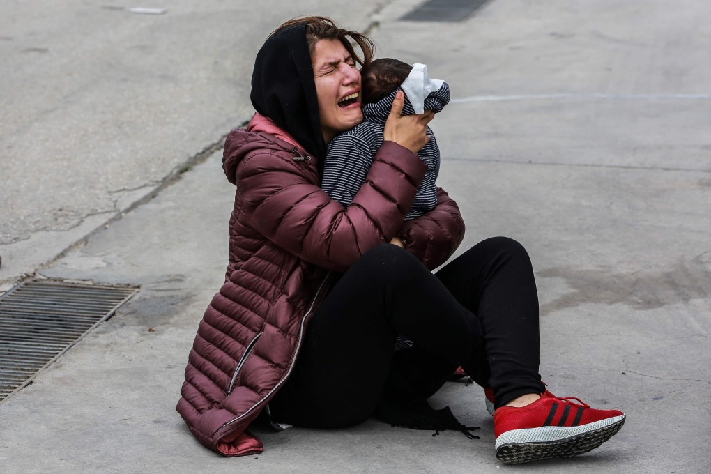 A migrant woman holds a child during clashes between refugees and police outside the Kara Tepe camp on the Greek island of Lesbos earlier this year. Photo: AFP