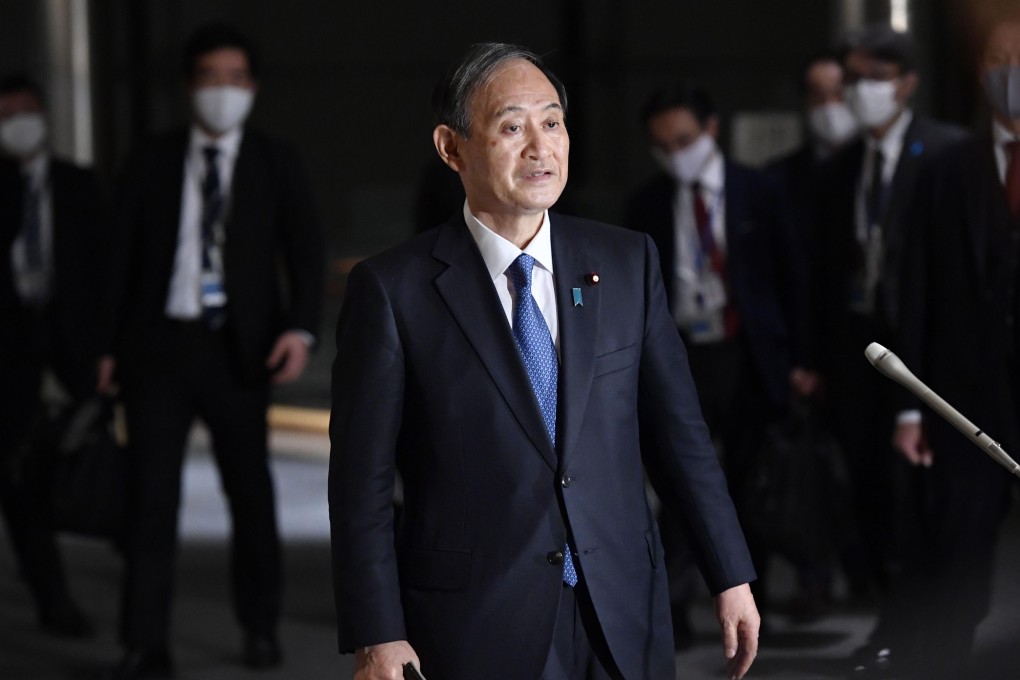 Japanese Prime Minister Yoshihide Suga speaks to reporters at his office in Tokyo on December 14. Photo: Kyodo