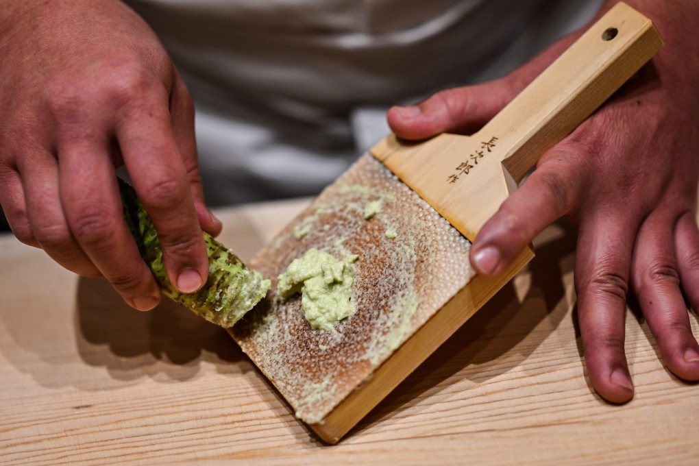 Japanese sushi master Toshiya Matsushita shreds fresh wasabi at his restaurant in Tokyo. He said artificial wasabi feels powdery and does not have much flavour. Photo: AFP