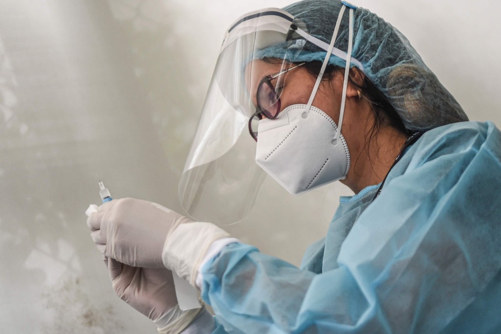 A health worker prepares to inoculate a volunteer with Sinopharm’s Covid-19 vaccine during a trial in Peru. Photo: AFP