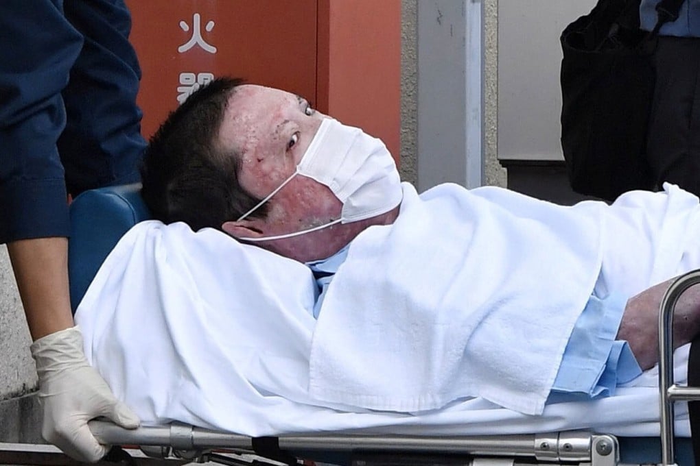 Shinji Aoba, who was charged with killing 36 people at Kyoto Animation in July 2019, is seen on a stretcher as he is carried to a police station in May. Photo: Kyodo