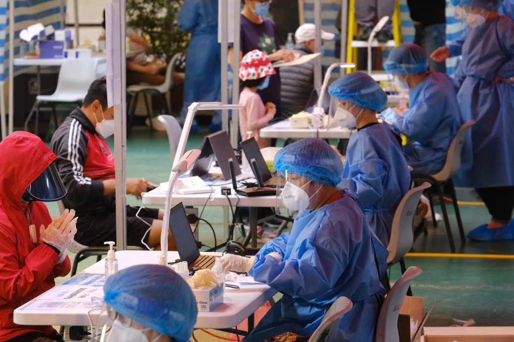 Medical workers in protective equipment test residents at a Covid-19 testing centre in Kowloon Bay, Hong Kong, on December 10. Photo: Bloomberg