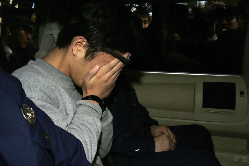 Takahiro Shiraishi covers his face with his hands after he was arrested in 2017. He confessed to killing nine people in a two-month spree after contacting them via Twitter. Photo: AFP