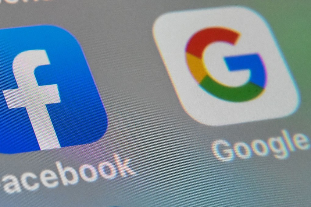 (FILES) In this file photo illustration taken on October 01, 2019, shows the logos of mobile apps Facebook and Google displayed on a tablet in Lille France. - Facebook and Google have extended their bans on political ads in the US amid misinformation circulated aimed at bolstering claims by President Donald Trump of fraud in his loss to Joe Biden. (Photo by DENIS CHARLET / AFP)