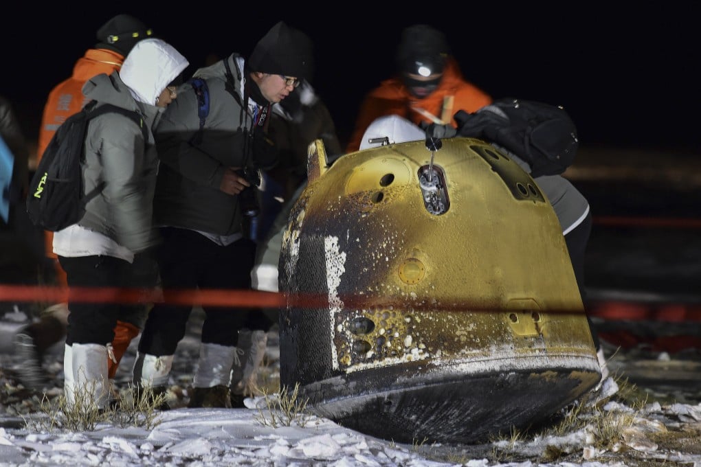The recovery crew checks on the Chang’e 5 capsule after its return from the moon. Photo: Xinhua