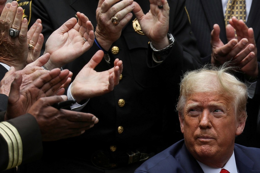 US President Donald Trump listens to applause after signing an executive order at the White House in June. Photo: Reuters