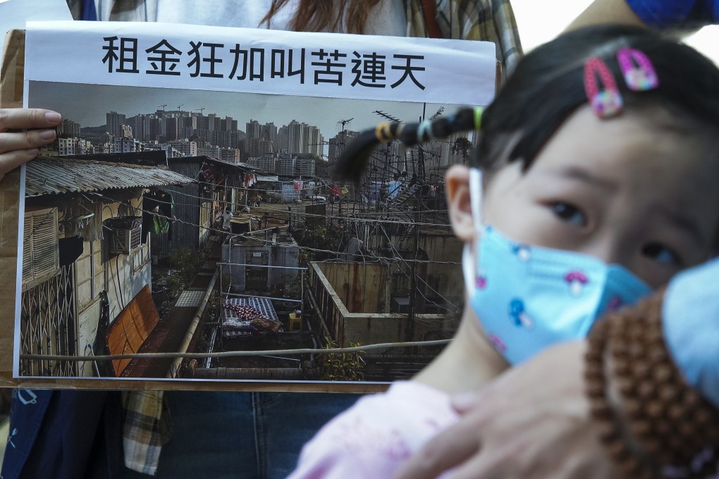A child takes part in an NGO-led demonstration outside the venue for a public forum on tenancy control of subdivided units, in Mong Kok on November 1. The average wait for public housing in Hong Kong has risen to 5.6 years, forcing many to live in poorly maintained subdivided flats in rundown urban buildings. Photo: Winson Wong