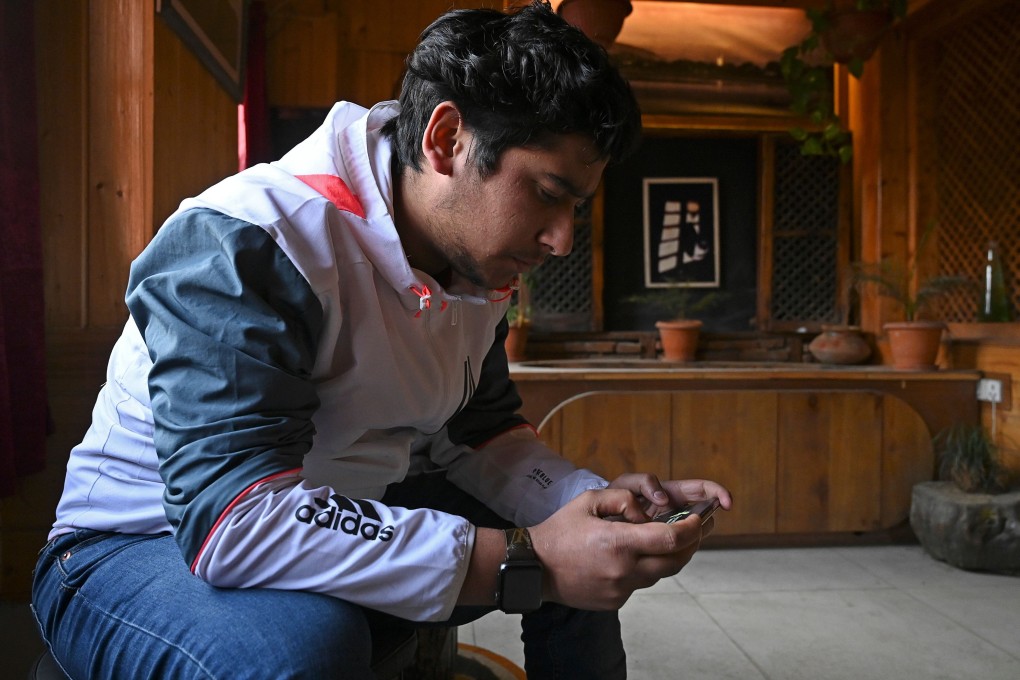 Zeyan Shafiq plays the PUBG mobile game in Srinagar, after reaching across the border to Pakistan to find other gamers. Photo: AFP