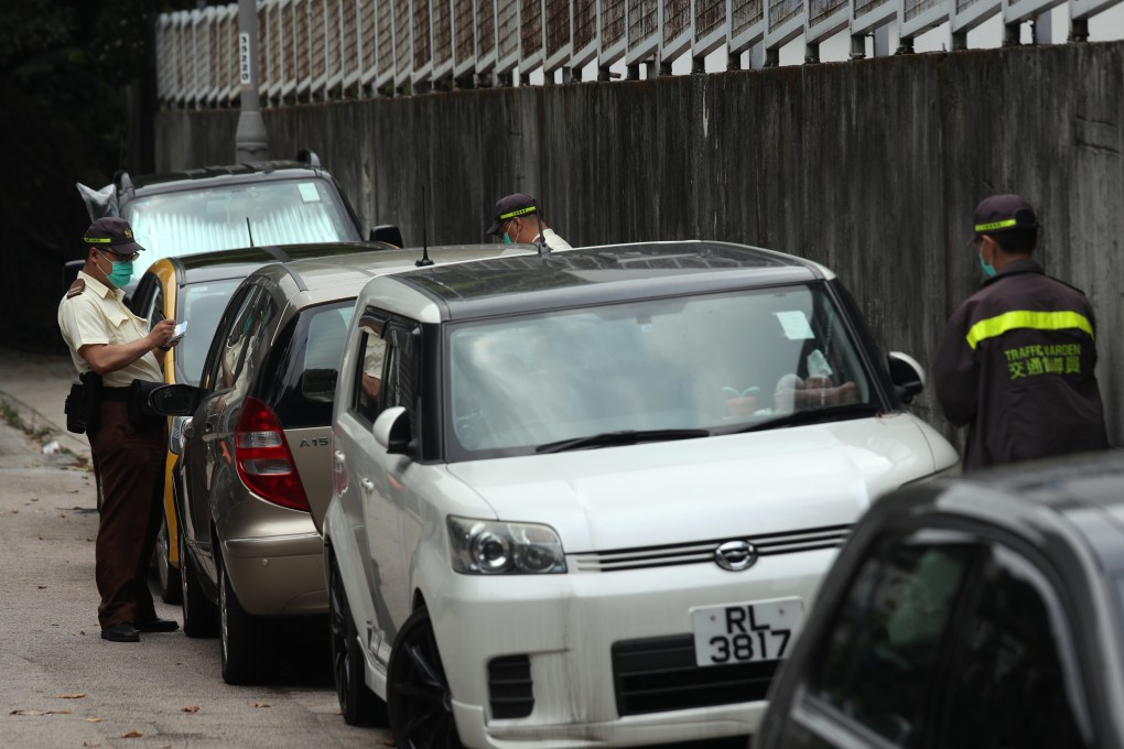 Traffic wardens give out tickets to illegally parked cars in Shau Kei Wan, a quiet neighbourhood in Hong Kong’s Eastern district, on March 27. Photo: Xiaomei Chen