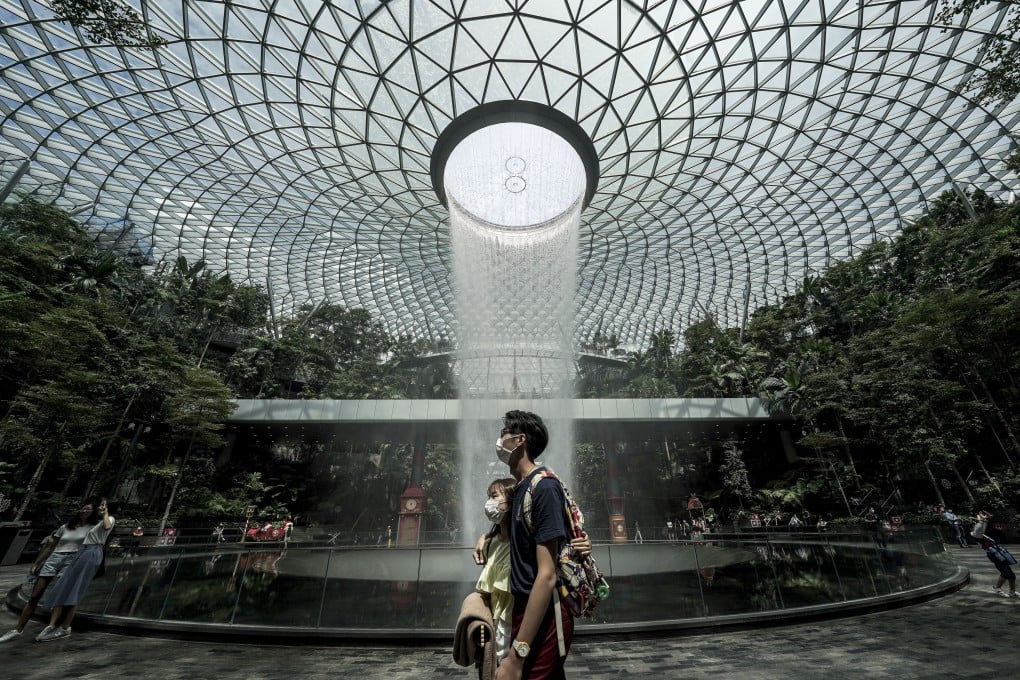 People walk past the Rain Vortex waterfall at the Jewel Changi airport mall in Singapore. Photo: EPA-EFE