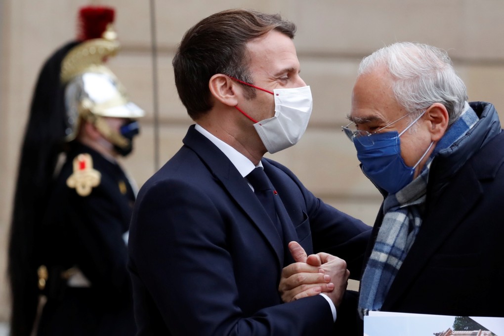 French President Emmanuel Macron shakes hands with OECD Secretary General Angel Gurria at the Elysee Palace on Monday. Photo: Reuters