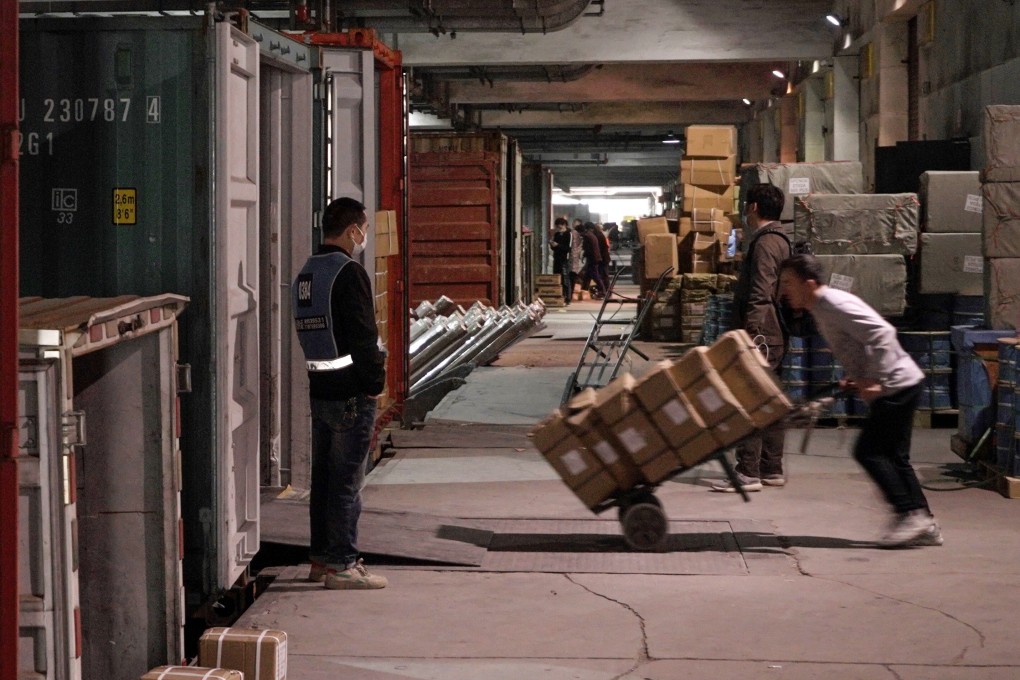 Workers pack containers in Yiwu, an inland port home to dozens of warehouses, where many exporters have recently seen their bank accounts frozen for weeks or months – often by police located in other Chinese provinces. Photo: Ren Wei