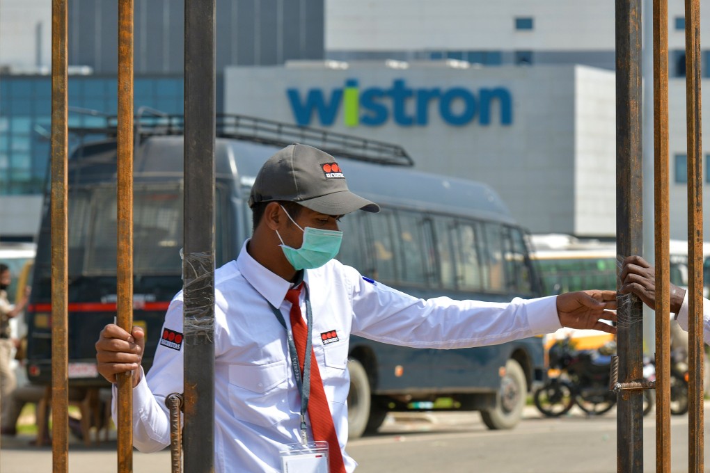 Private security personnel guard the entrance of a Taiwanese-run iPhone factory at Narsapura, about 60 km from Bangalore. Photo: AFP