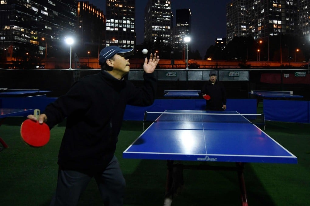 A table tennis match under lights at a park opposite Beijing’s central business district. Photo: AFP
