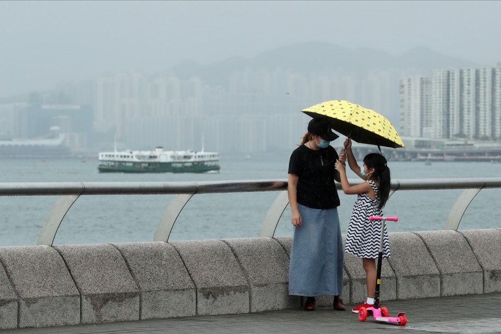 Mother and child at Tamar Park on August 18. Many companies still let go of women first, assuming that men are always the breadwinners and forgetting that many mothers are single parents. Photo: Edmond So