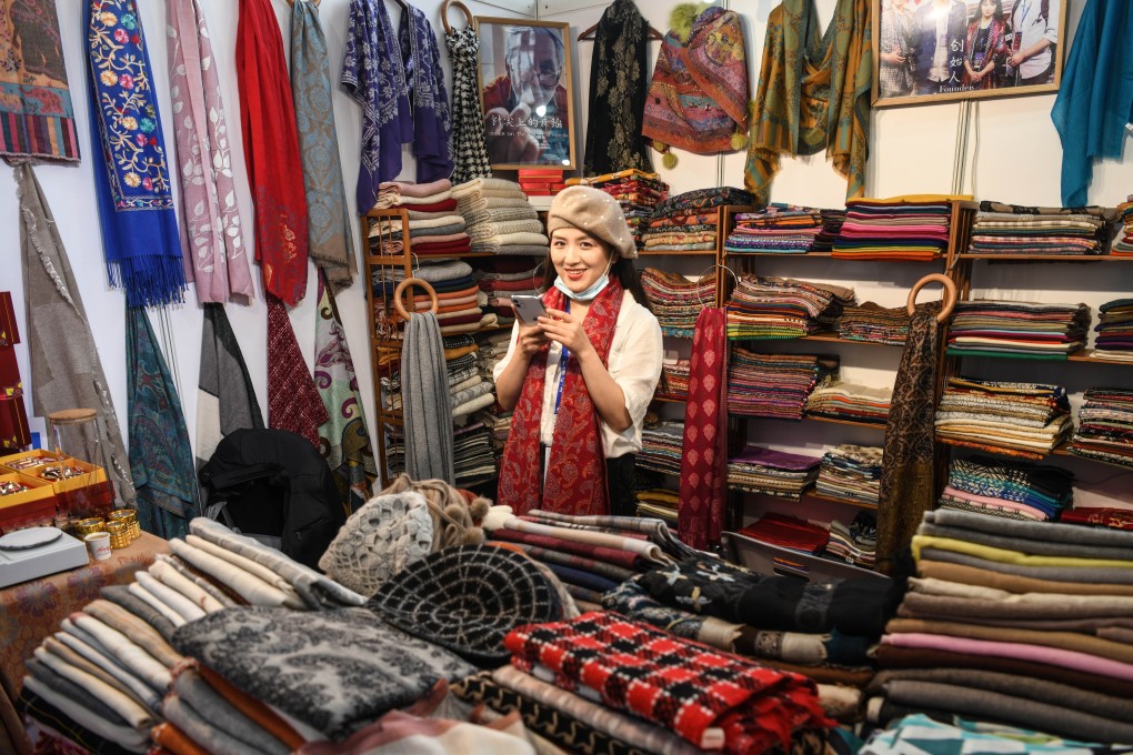 An exhibitor sells goods at the “Belt and Road” exhibition area of the 17th China-Asean Expo in Nanning, Guangxi, on November 27. The belt and road is an idea rather than a project, and lends its name to multiple projects and events, even theme songs, cartoons, courses and think tanks. Photo: Xinhua