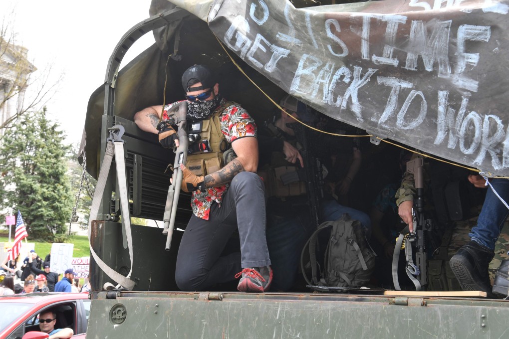 People take part in a “reopen” Pennsylvania demonstration on April 20, 2020 in Harrisburg. The roots of resentment in Trump supporters are complex and signal an anger most non-Americans have difficulty comprehending. Photo: AFP