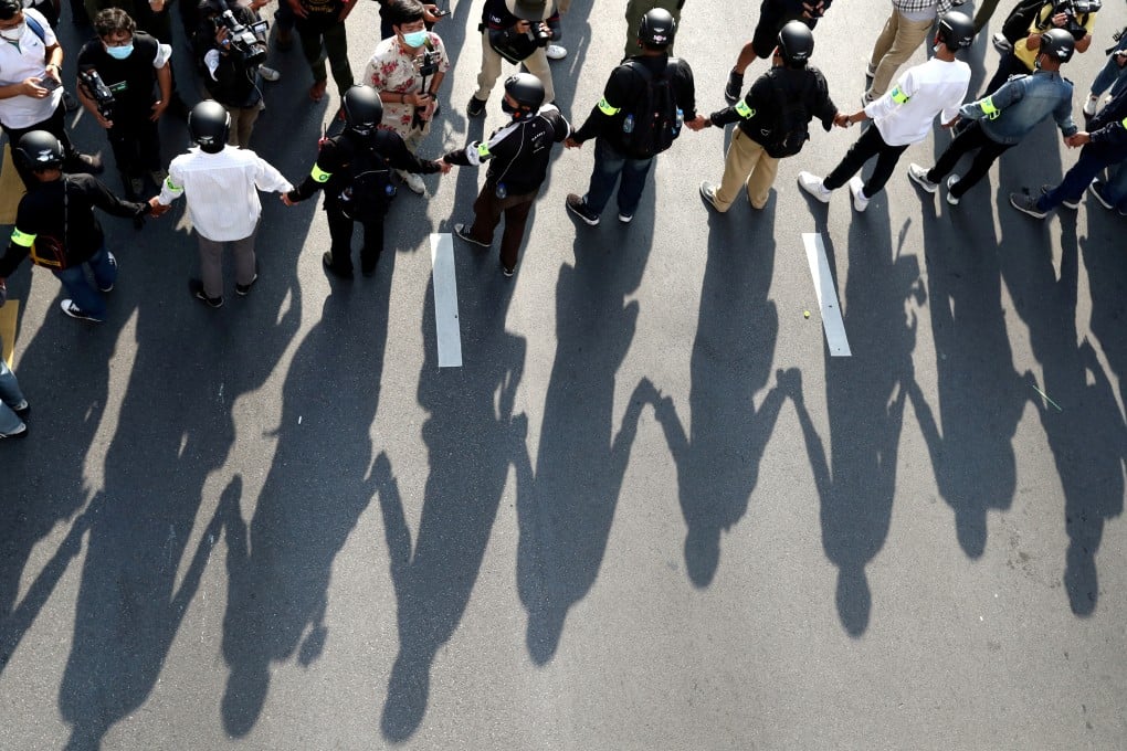 Security personnel form a human chain during a Thai anti-government mass protest in Bangkok in October on the 47th anniversary of the 1973 student uprising. Photo: Reuters