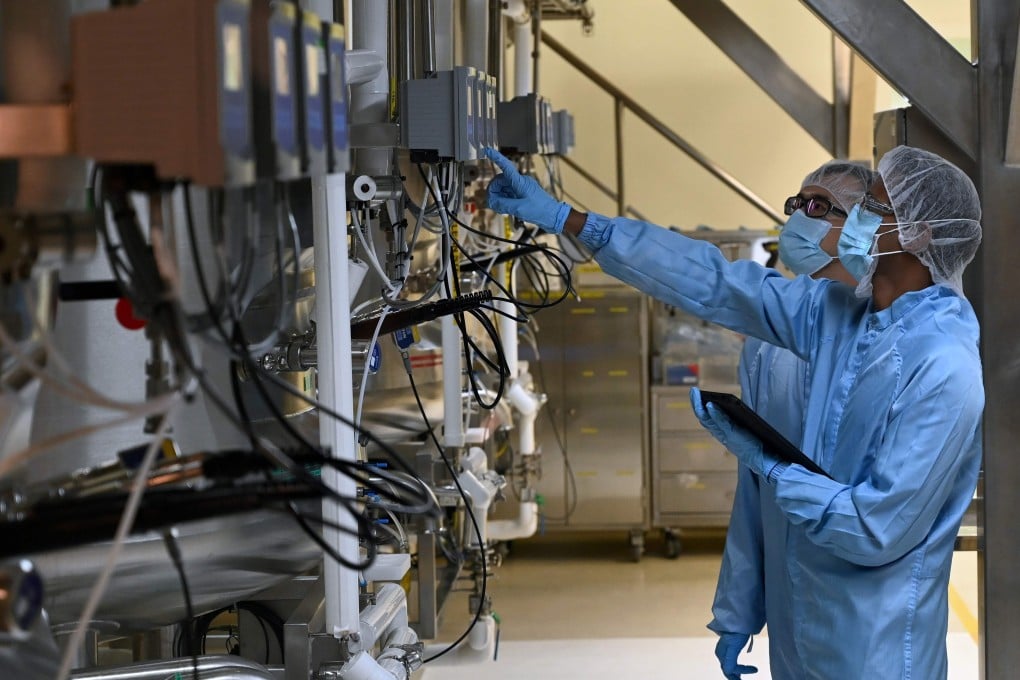 Scientists check a bioreactor used for manufacturing medical products at Takeda Pharmaceuticals in Singapore. Photo: AFP