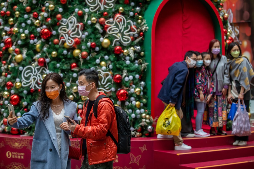 People take photos in front of a Christmas tree in the Wan Chai district of Hong Kong on December 12. Photo: Bloomberg