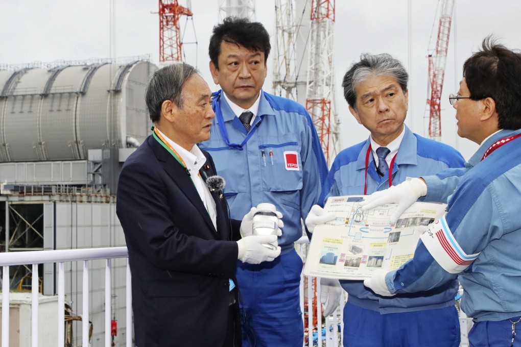 Japanese Prime Minister Yoshihide Suga, left, visits the disaster-stricken Fukushima Daiichi nuclear power plant Japan in September. Photo: Kyodo