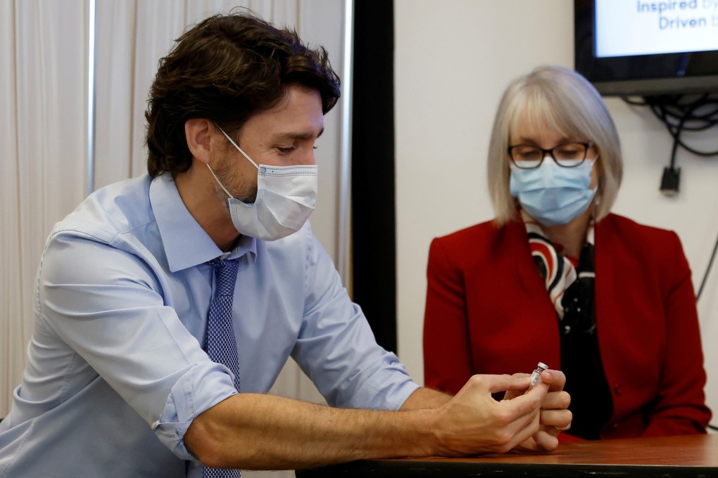 Canada's Prime Minister Justin Trudeau, with Minister of Health Patty Hajdu, holds an empty Covid-19 vaccine vial. Photo: Reuters