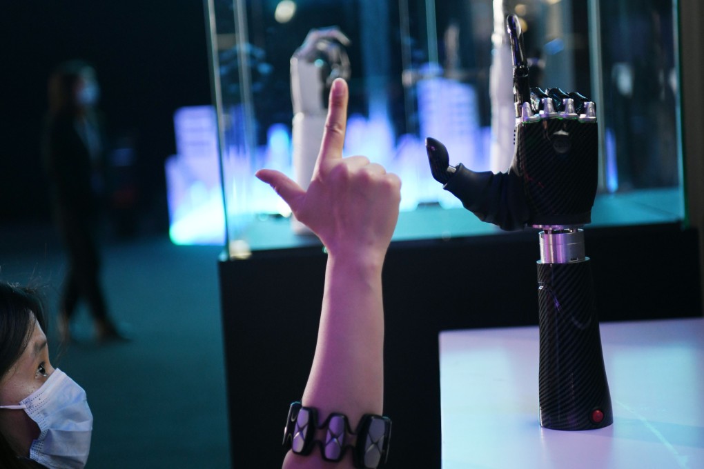 An employee demonstrates a wearable AI-powered bionic hand at the JD Global Technology Discovery Conference in Beijing in November. Photo: Xinhua