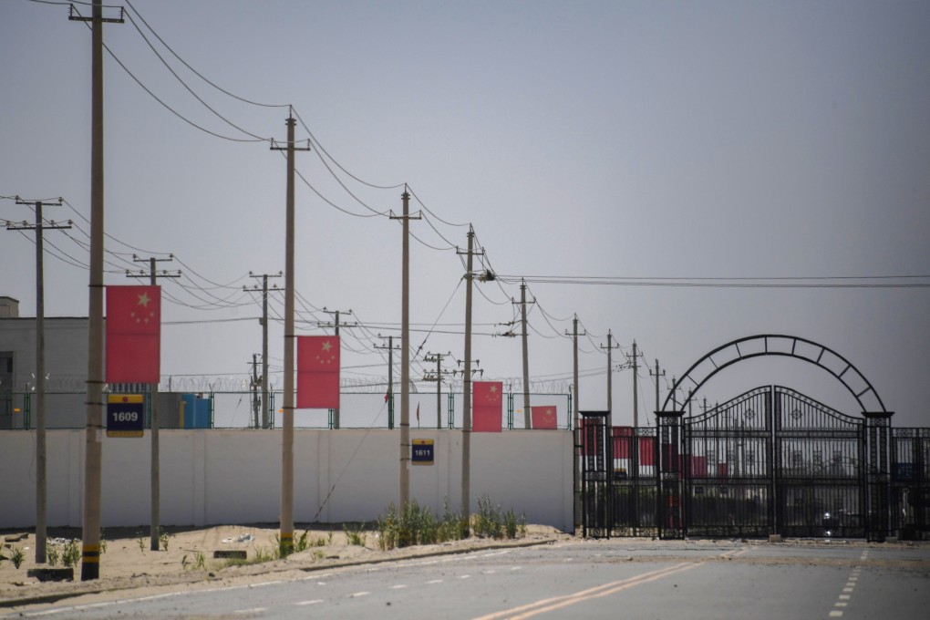 Chinese flags on a road leading to a facility believed to be a re-education camp on the outskirts of Hotan in Xinjiang. Photo: AFP