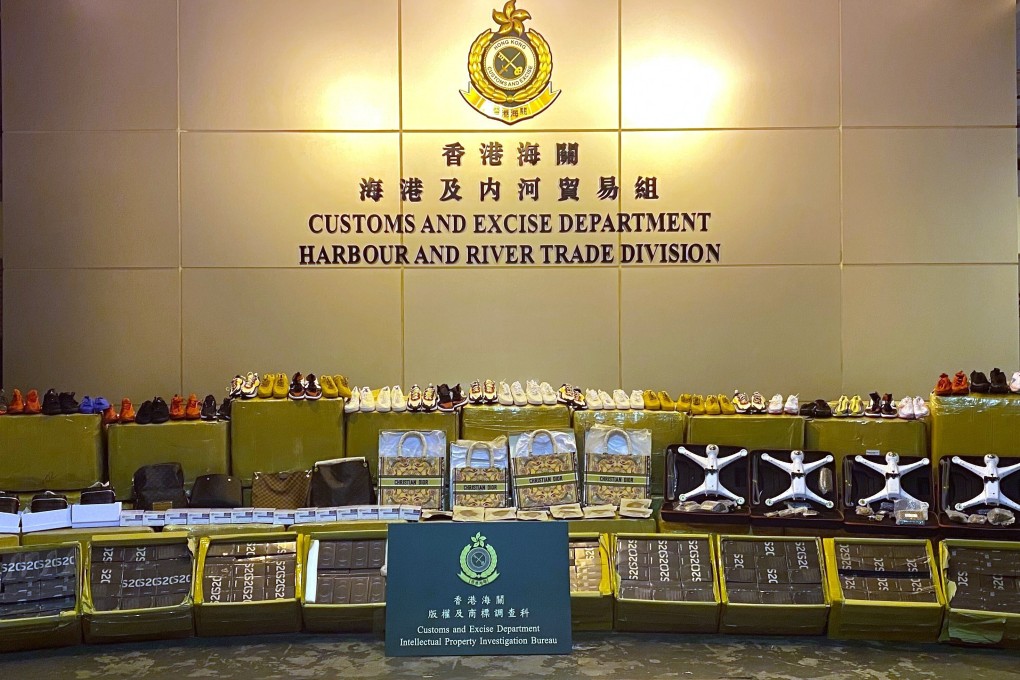 Hong Kong customs officials display the 63,000 pieces of suspected counterfeit goods seized last Friday. Photo: Handout