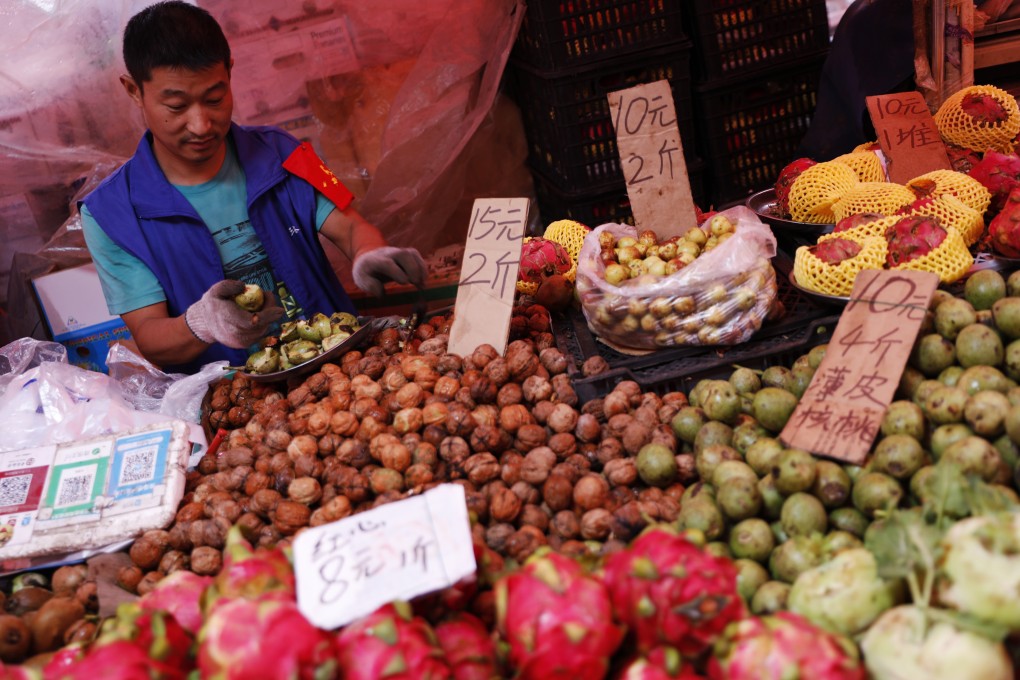 Community group buying enables residents to purchase groceries and daily essentials in bulk via a community leader but regulators are concerned it might hurt small shop owners. Photo: EPA-EFE