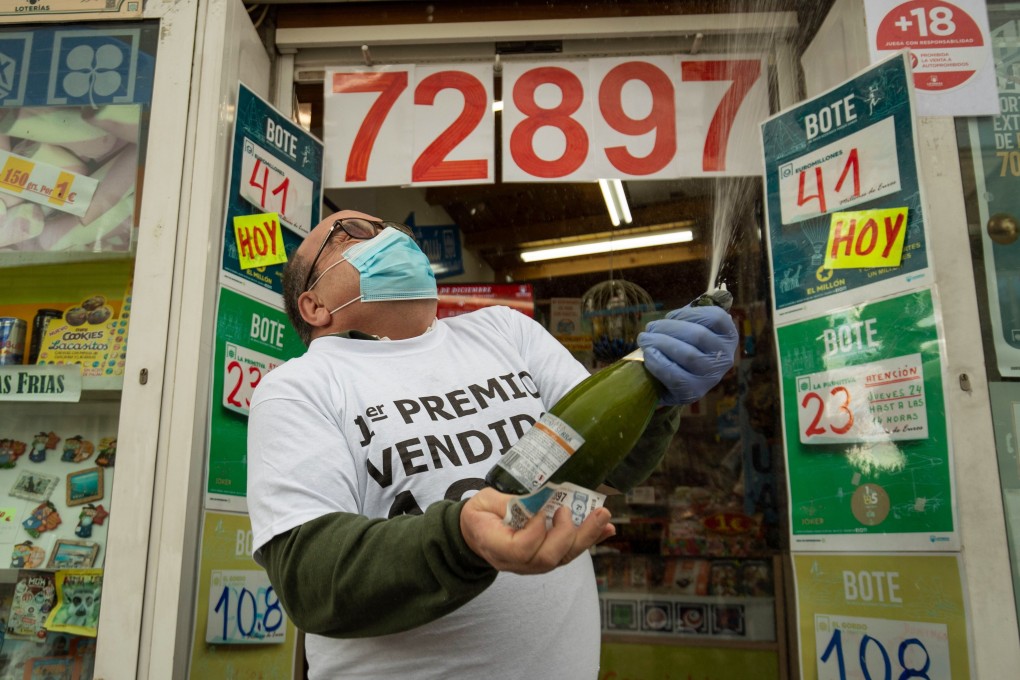 A lottery seller celebrates selling the first prize of Spain's Christmas lottery draw. Photo: AFP