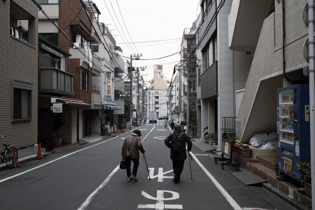 Elderly residents walk along a street in the Toshima district of Tokyo. Photo: Bloomberg
