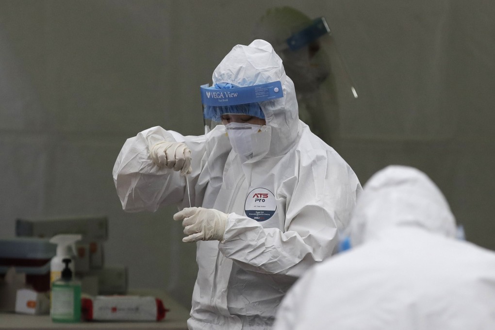 Medical workers wearing protective gears work at a coronavirus testing site in Seoul, South Korea. Photo: AP