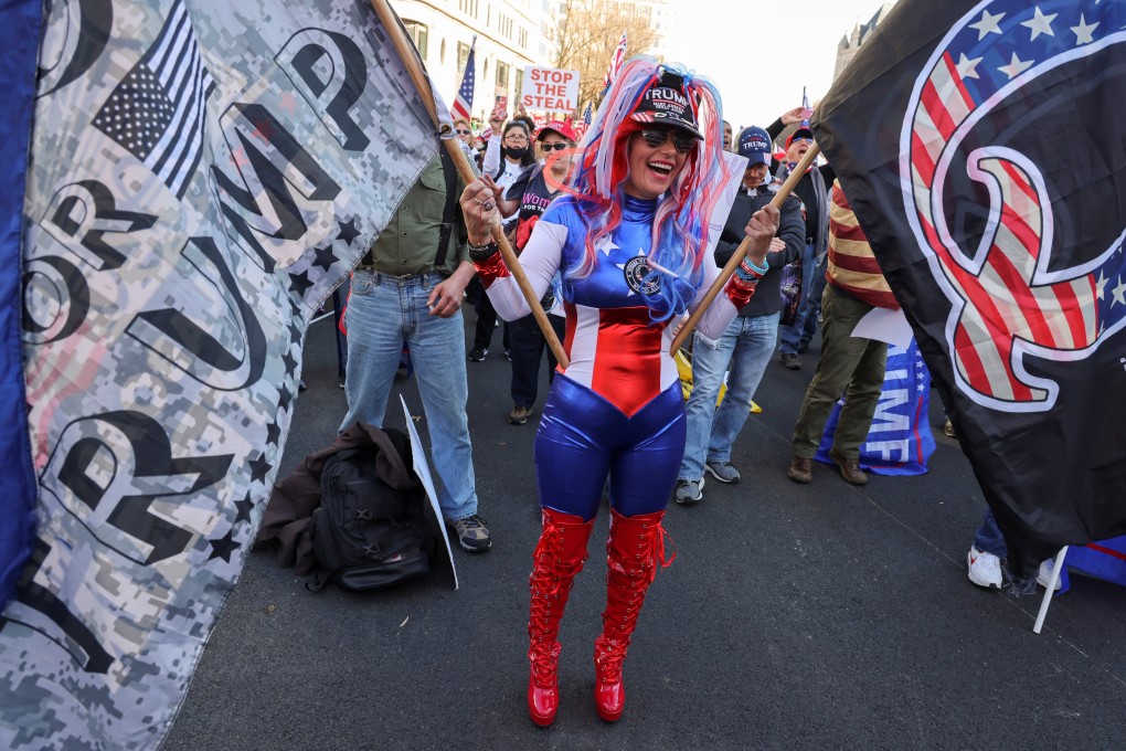 A person holds a QAnon flag during a rally to protest the results of the US election in Washington. Photo: Reuters