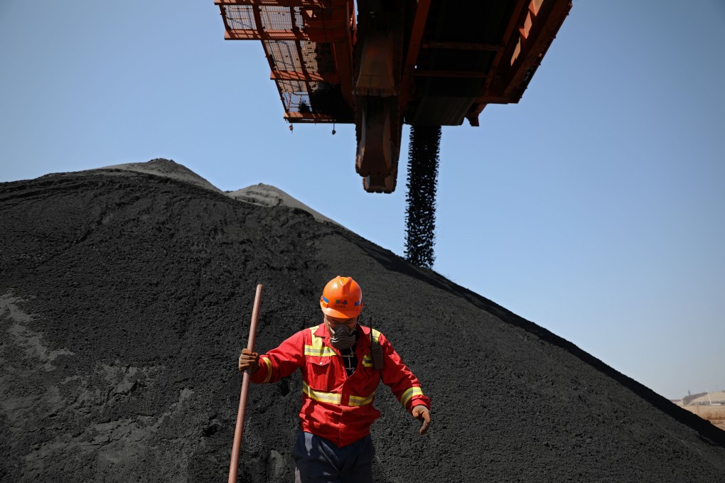 Iron ore fine is loaded at the Dalian port in China’s Liaoning province. Photo: Xinhua