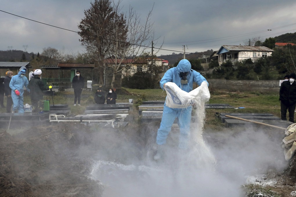 A volunteer prepares a grave for a funeral of a person who died from Covid-19 at a cemetery in Ghaemshahr, northern Iran. Photo: AP