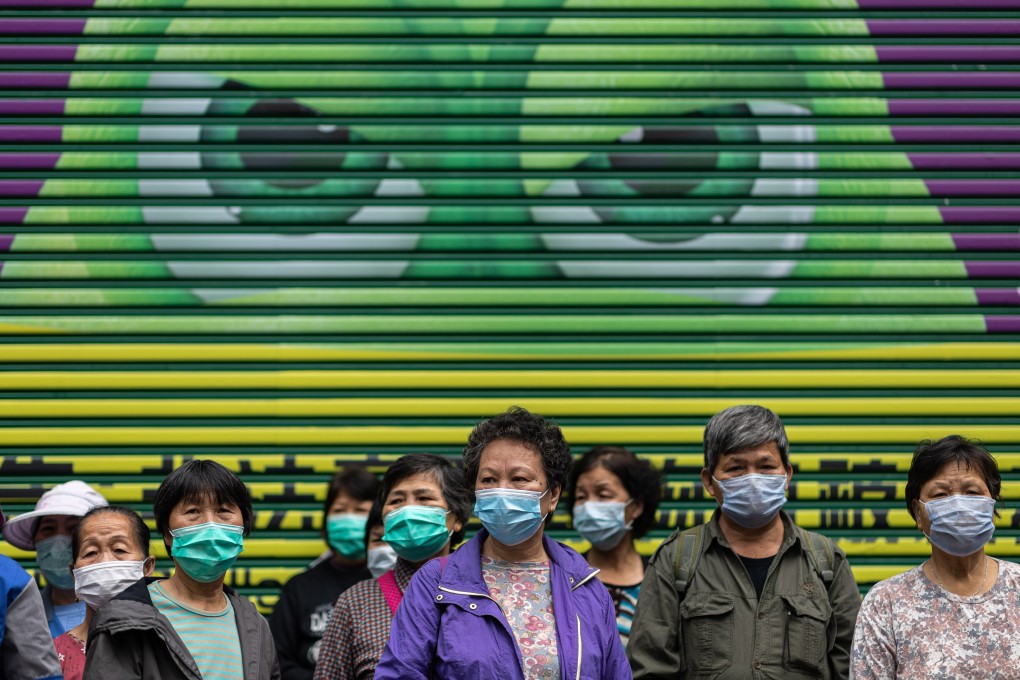 Street cleaners wait in line to receive free face masks in Hong Kong on February 14. Photo: EPA-EFE