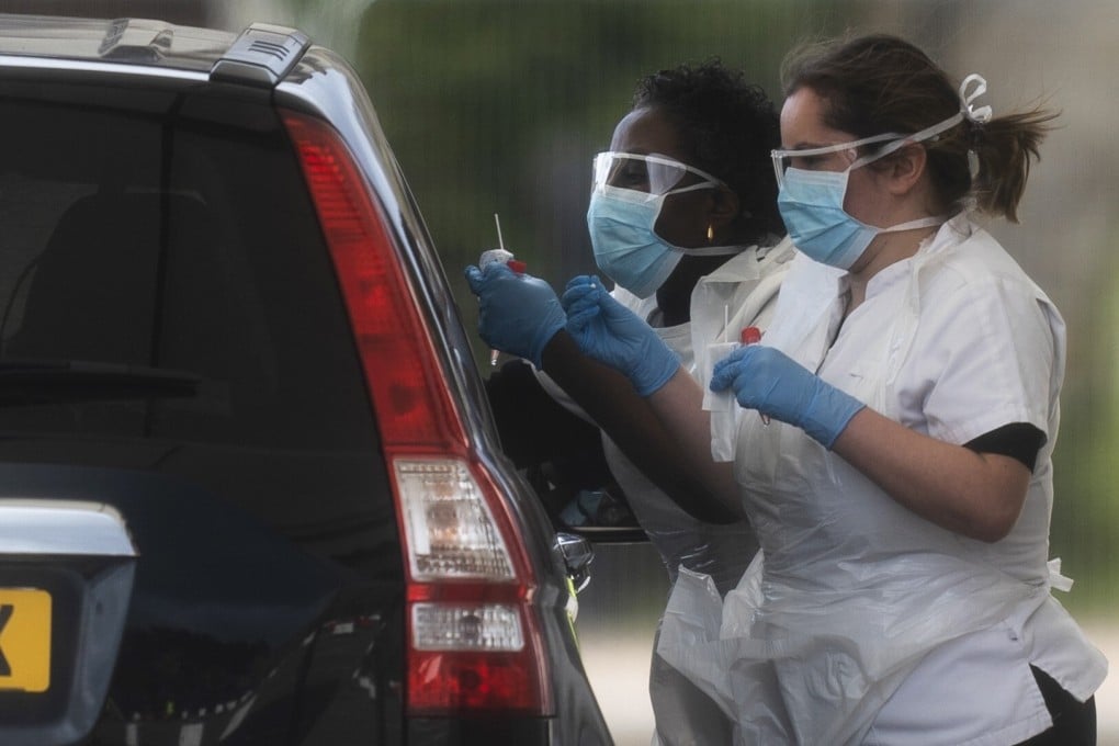 Medical workers at a drive-through coronavirus testing facility in Chessington World of Adventures, London. File photo: EPA-EFE