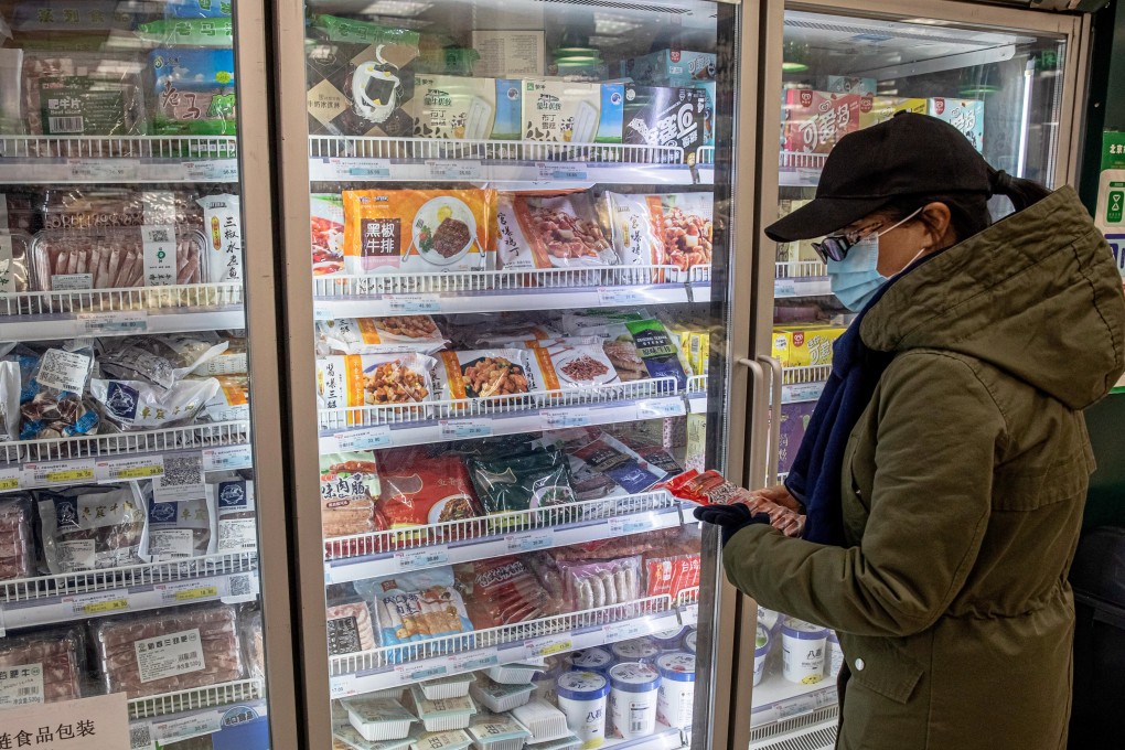 A woman shops at a frozen food section at a store in Beijing. Photo: EPA-EFE