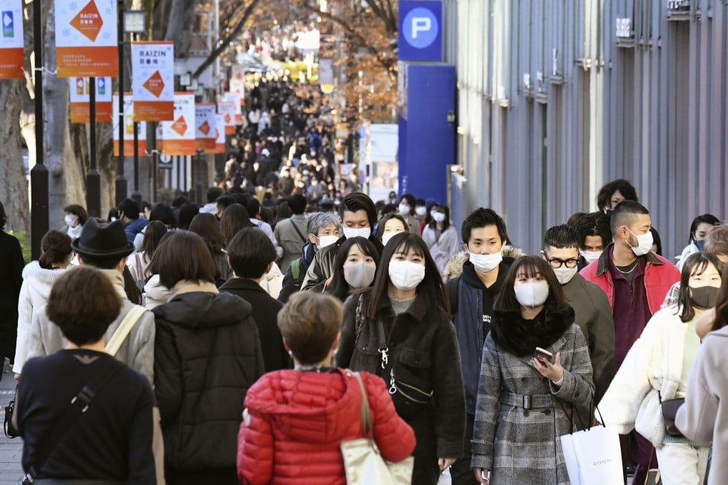 People wear face masks in Tokyo, Japan on Sunday. Photo: Kyodo News via AP