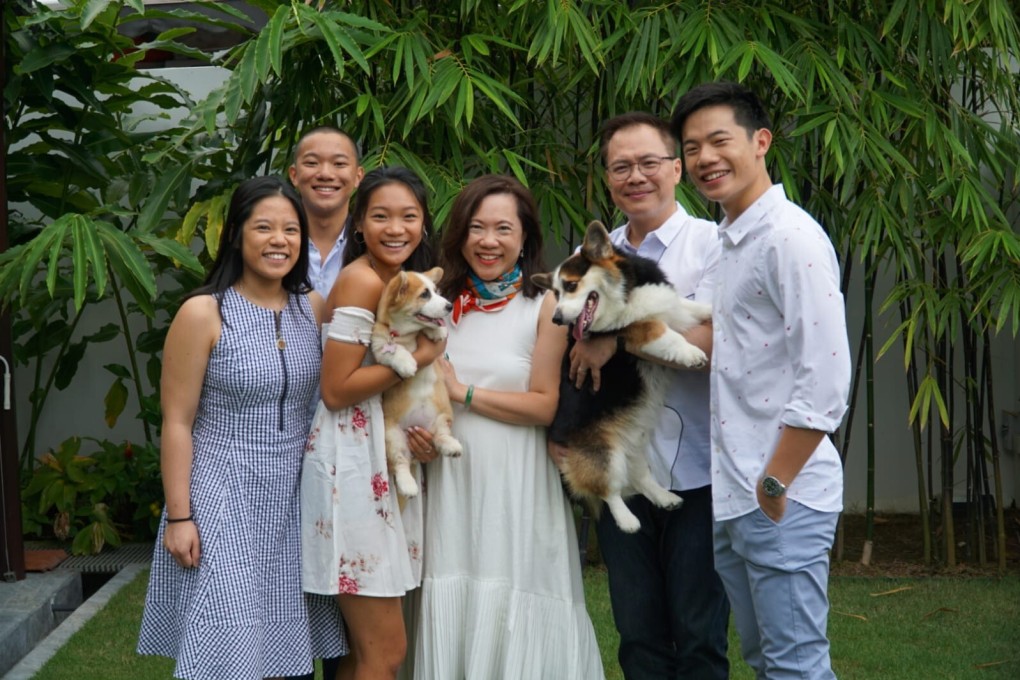 The Chan family in Singapore, including Kristyn and her father Gabriel (both holding dogs). He and his wife (centre) helped Kristyn cope with the effects of ADHD and, like many carers, felt confused, anxious and frustrated. Photo: courtesy of Gabriel Chan