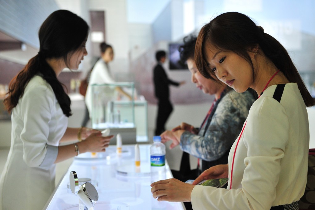 A customer looks at various products at the Korea Beauty and Cosmetic Expo in Goyang, north of Seoul. Photo: AFP