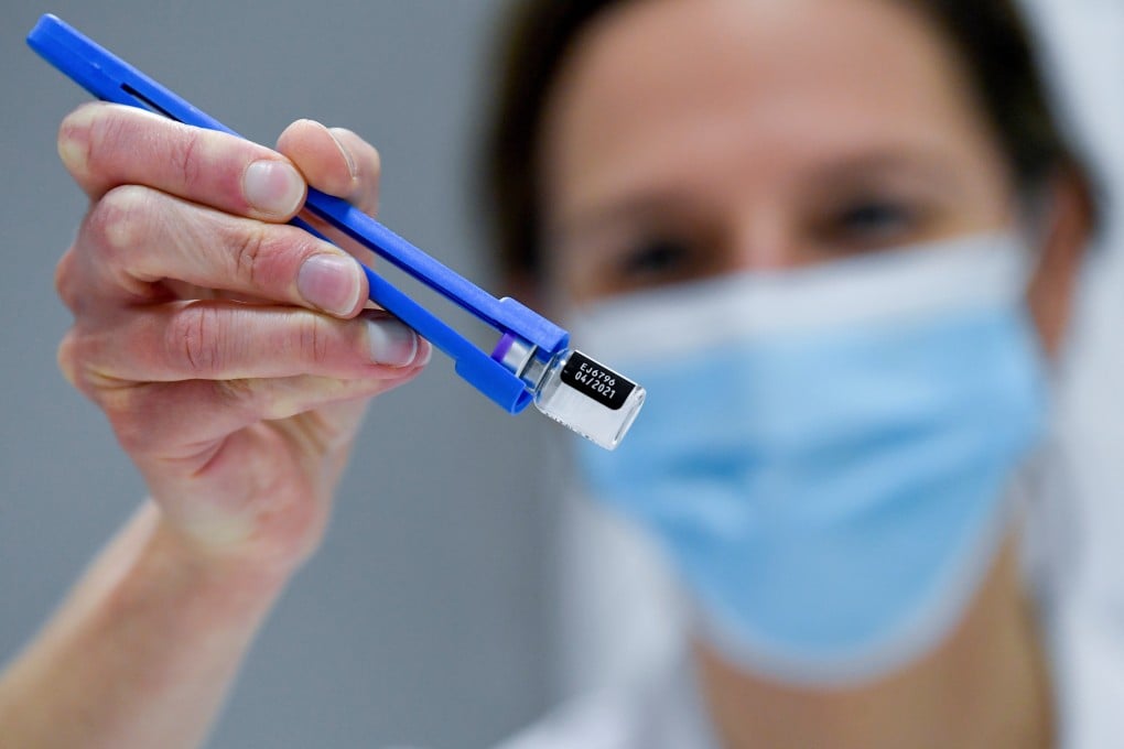 The first Pfizer/BioNTech Covid-19 vaccines for Belgium are defrosted at a hospital. As vaccination against the virus is rolled out around the world, governments will be calculating how much of their people need to receive the vaccine to achieve herd immunity and allow a return to normality. Photo: Fred Sierakowski/Pool via Reuters