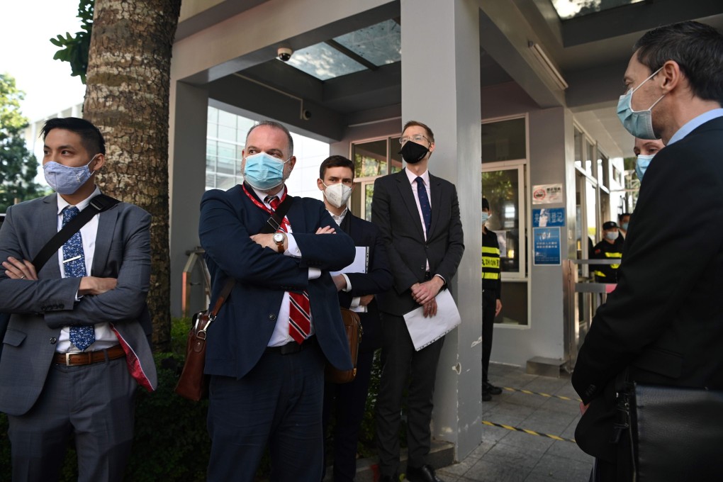 Diplomats from the US, Britain, Australia, Canada, Portugal and the Netherlands wait outside the Yantian People’s Court on Monday. Photo: AFP