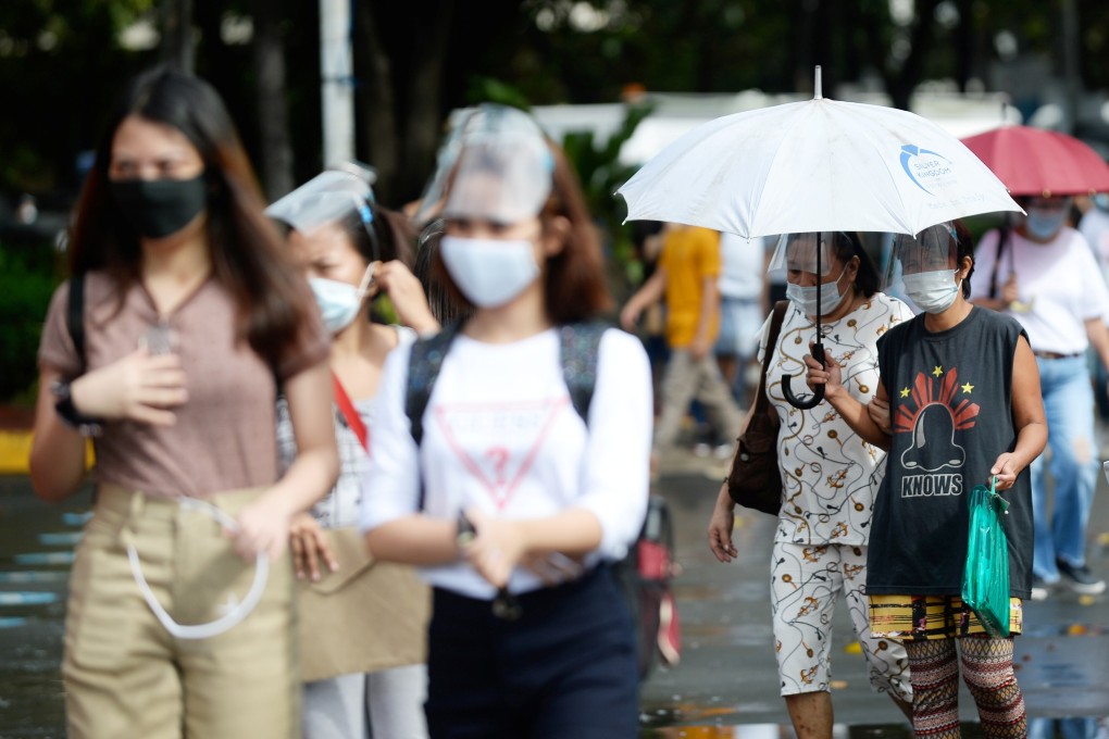 People seen in face masks and face shields in Manila. Photo: Reuters