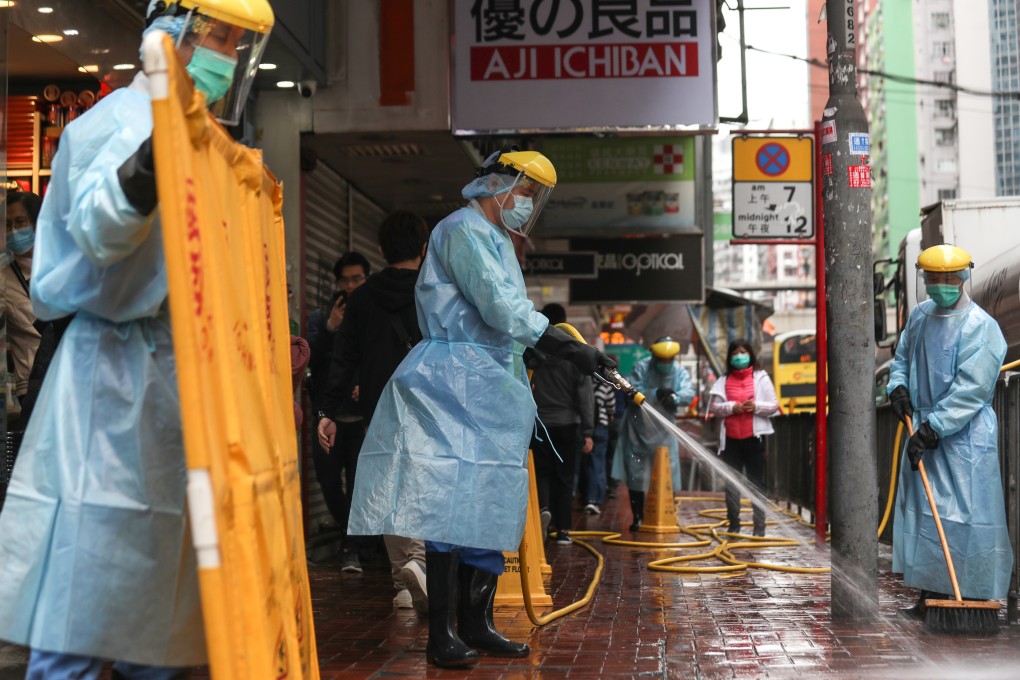 Workers in protective gear clean Shu Kuk Street and King's Road outside Maylun Apartment in North Point, where Fook Wai Ching She Buddhist Worship Hall is located. Photo: Xiaomei Chen