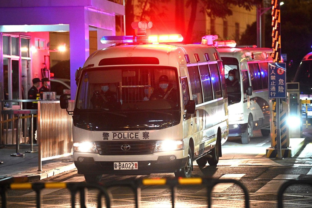 Police vehicles exit the Yantian People’s Court on Monday night. Photo: AFP